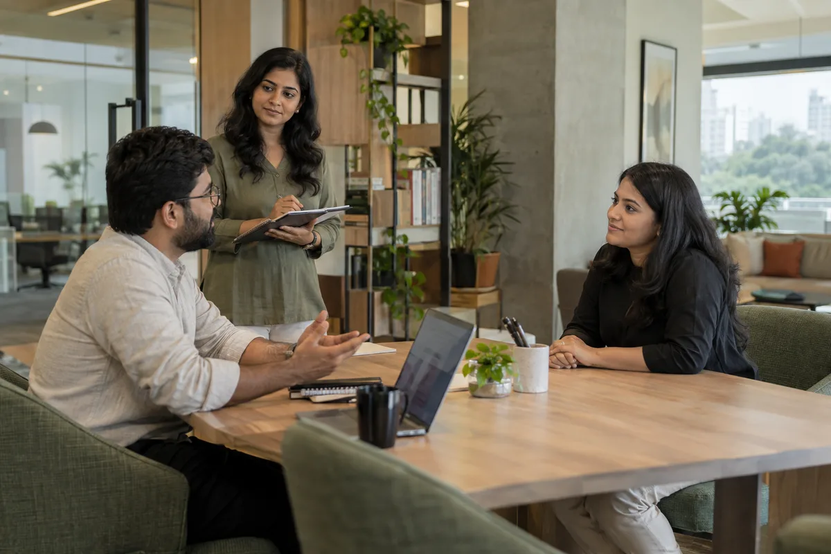 A trainer observing a hiring manager practising an interview with an adult colleague.